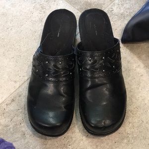 Black leather clogs.